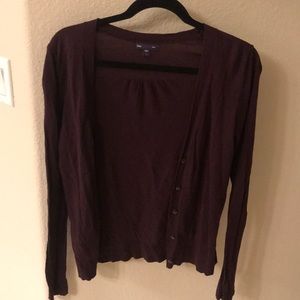 A purple/mauve button down sweater